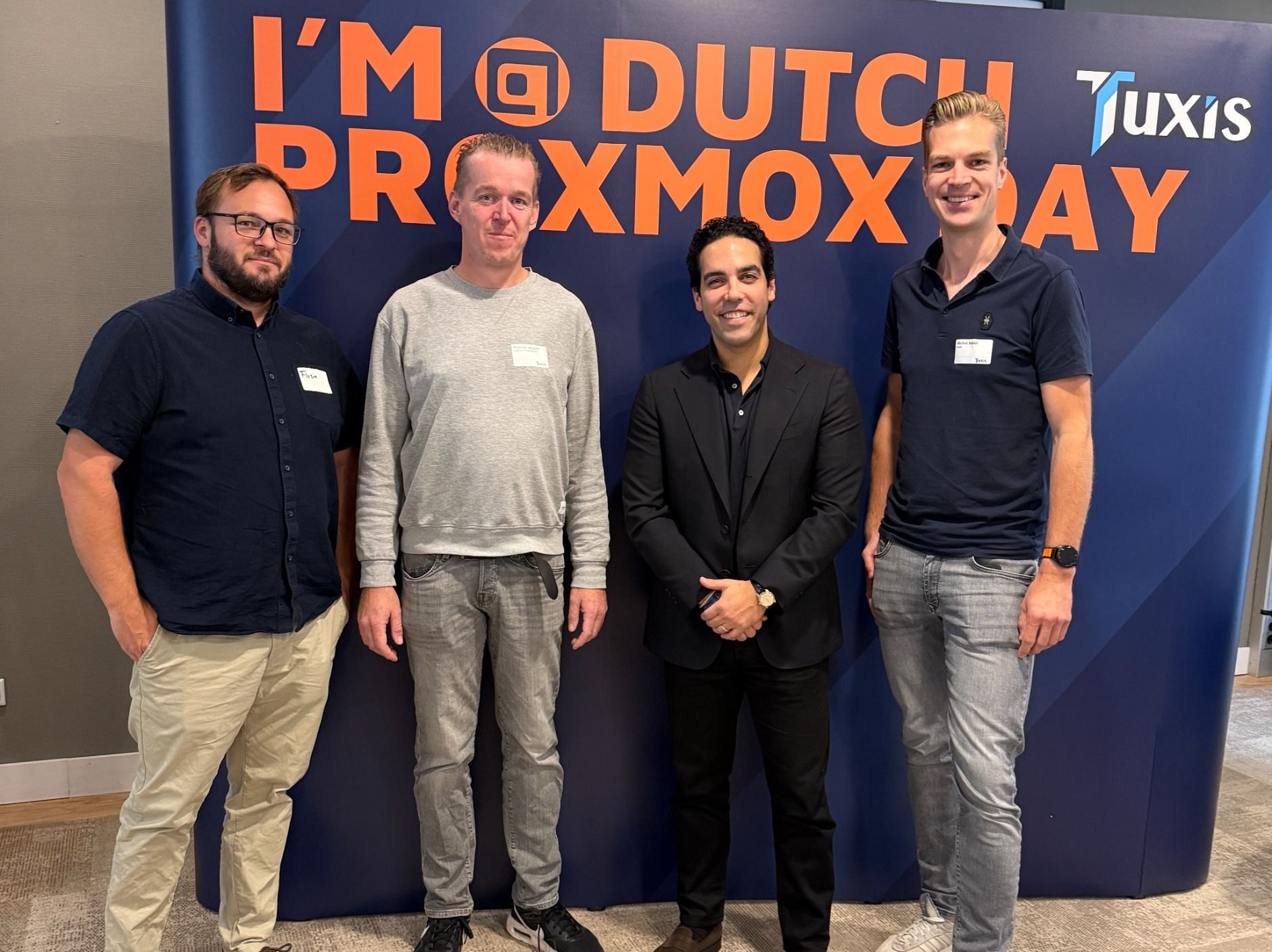 Bardia Khalilifar and Florin Cazacu with the e-Quest team in front of the Dutch Proxmox Day backdrop